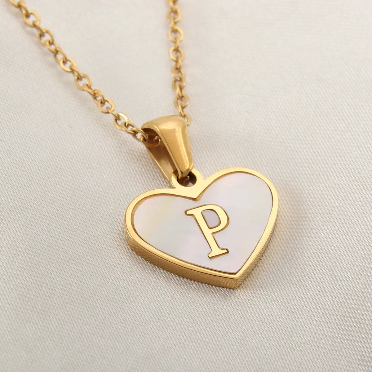 Gold plated heart-shaped personalised necklace with white shell charm on an adjustable chain.