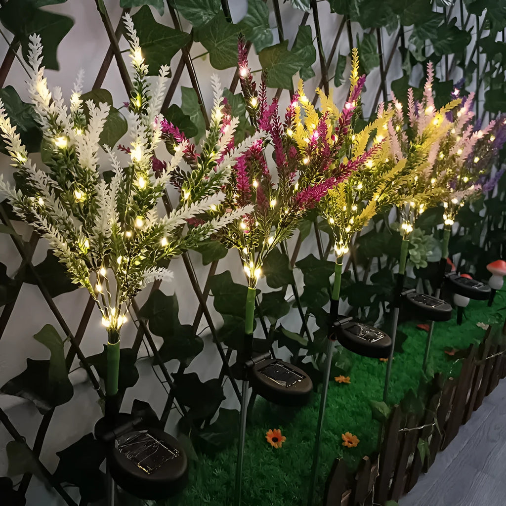A pink flower-shaped solar LED garden light standing 74 cm tall in an outdoor setting.