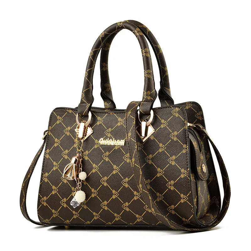 Women's geometric print PU leather messenger bag with internal organisers and zip closure.