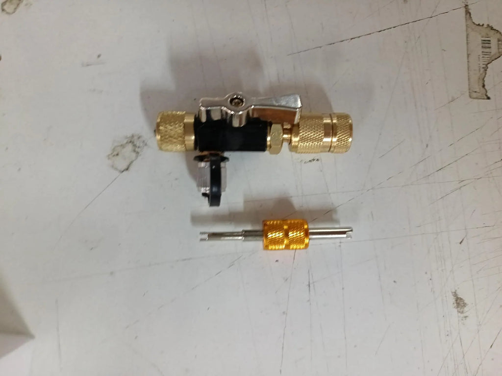 Metal valve core disassembly tool set showing black and pink valve removers and a valve core wrench.