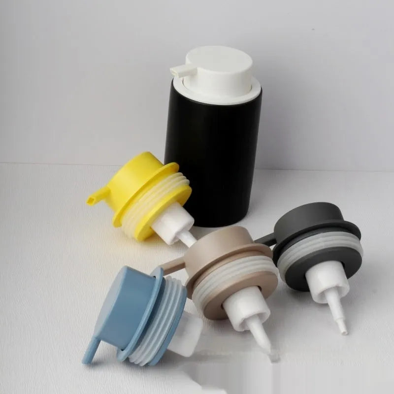 Foam pump facial cleanser dispenser with large plastic pump head in metallic finish
