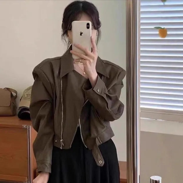 Women's brown retro imitation leather jacket with long sleeves, pockets, and a slim fit.