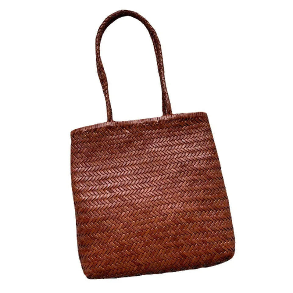 Brown handmade cowhide leather shoulder bag with woven tote design and three-dimensional pocket