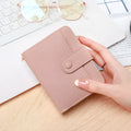 Ladies' short two-fold wallet in PU leather with a lychee pattern, shown in beige, pink, black, and red.
