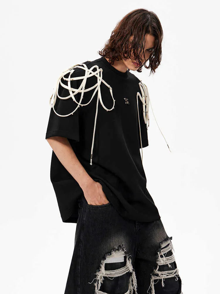 Black loose-fit short-sleeved T-shirt with a decorative rivet and ribbon padded shoulder detail.