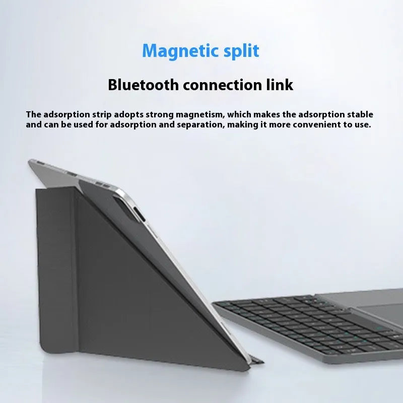 Grey Bluetooth folding keyboard unfolded next to mobile phone showing wireless connectivity for typing