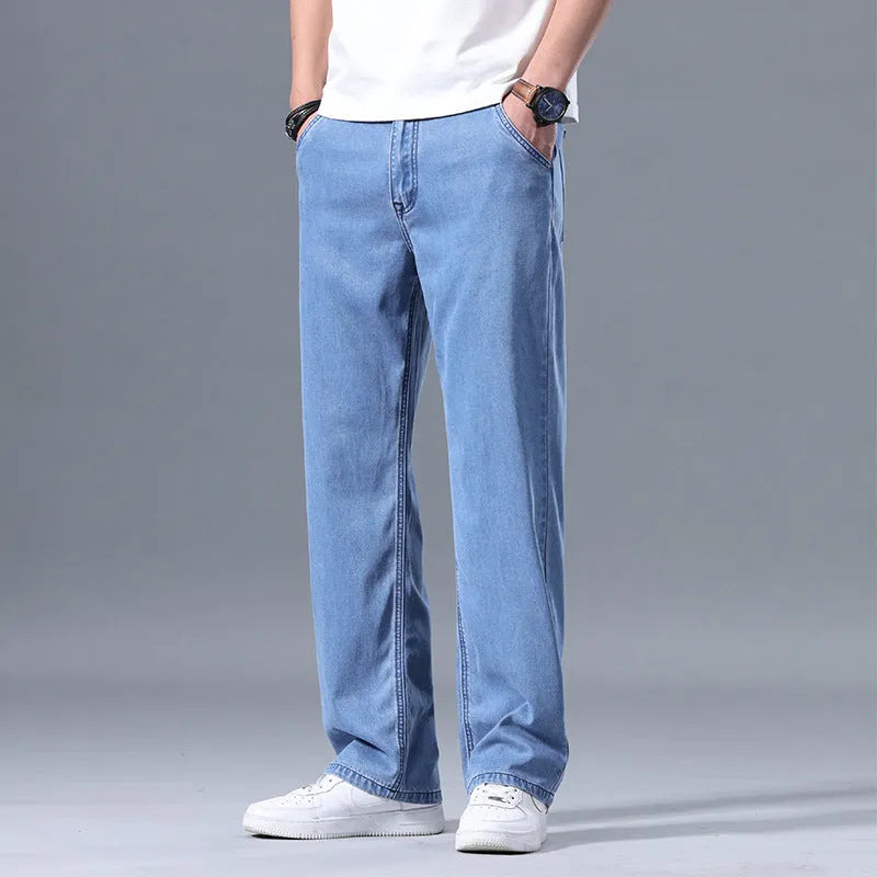 Man wearing loose straight-leg light blue Lyocell casual jeans with a zipper fly.
