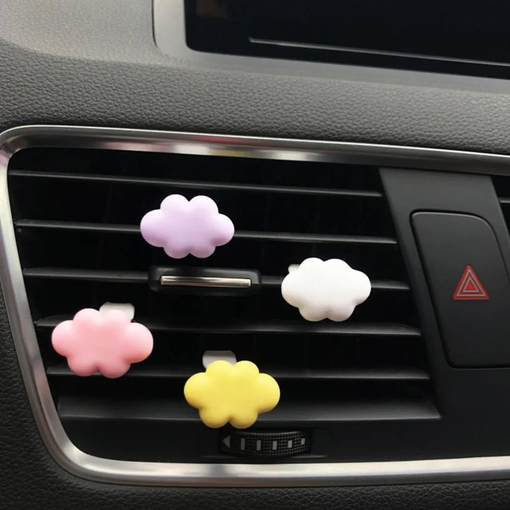 Baiyun cartoon car fragrance clip in resin, shown in various colours for air vent mounting.