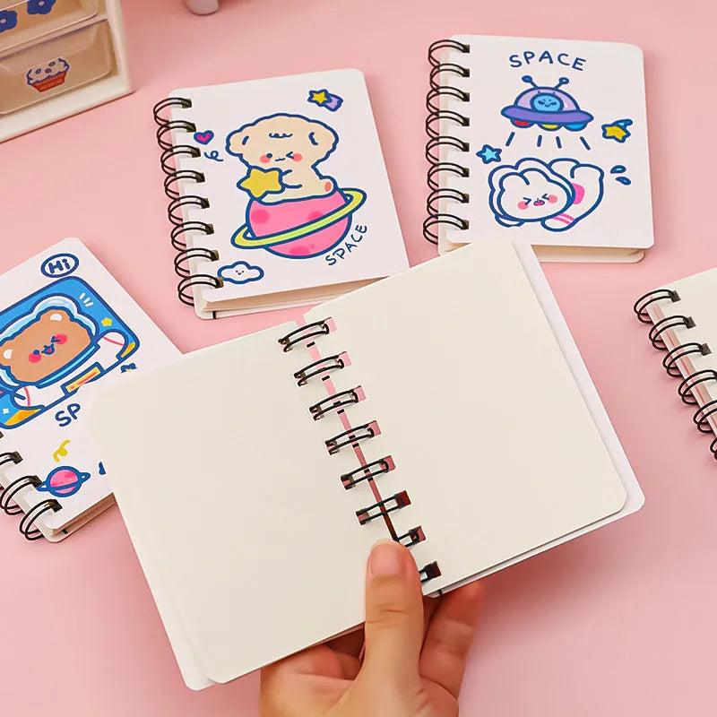 Astronaut themed flipper notebook showing compact 10.5cm by 8cm size with space artwork cover