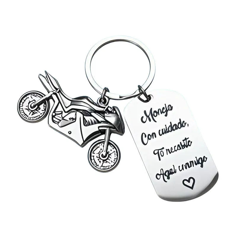 Stainless steel motorcycle keychain with a modern minimalist design, shown with a velvet flannel bag.