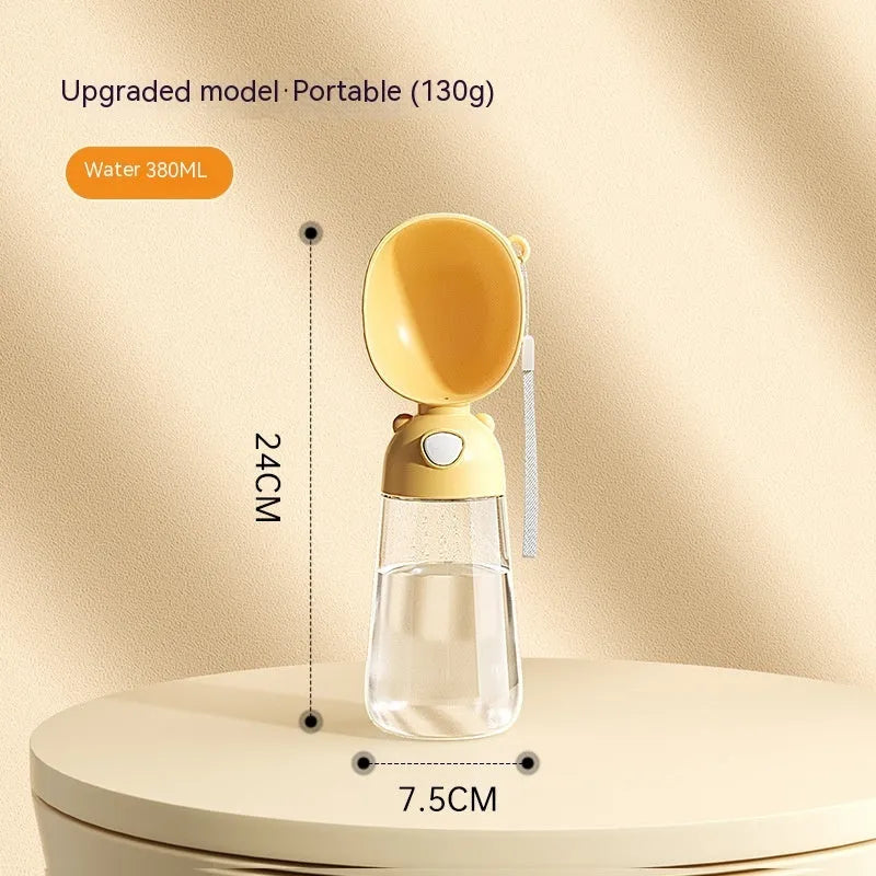 Portable dog water bottle with an attached feeding bowl in yellow, for outdoor travel.