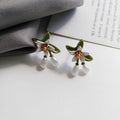 Alloy camellia flower earrings with sterling silver needle and contrasting colours including stud and clip options