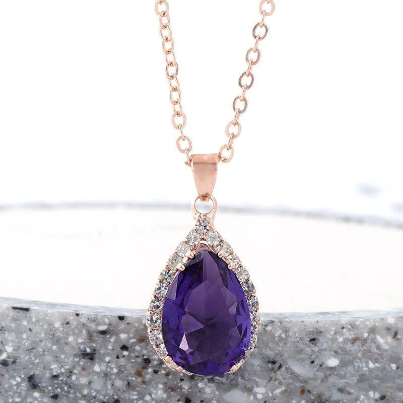 Rose gold plated drop pendant necklace with colourful rhinestones in a pink colour option.