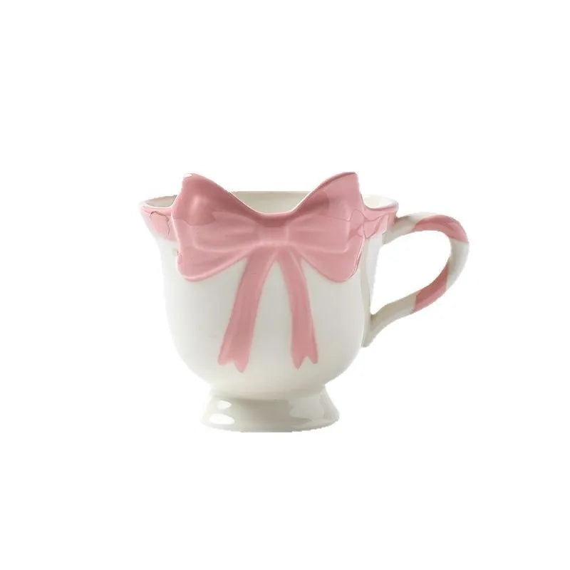 Ceramic mug with heart bow design in cute style showing Black Pink and White Powder colour options