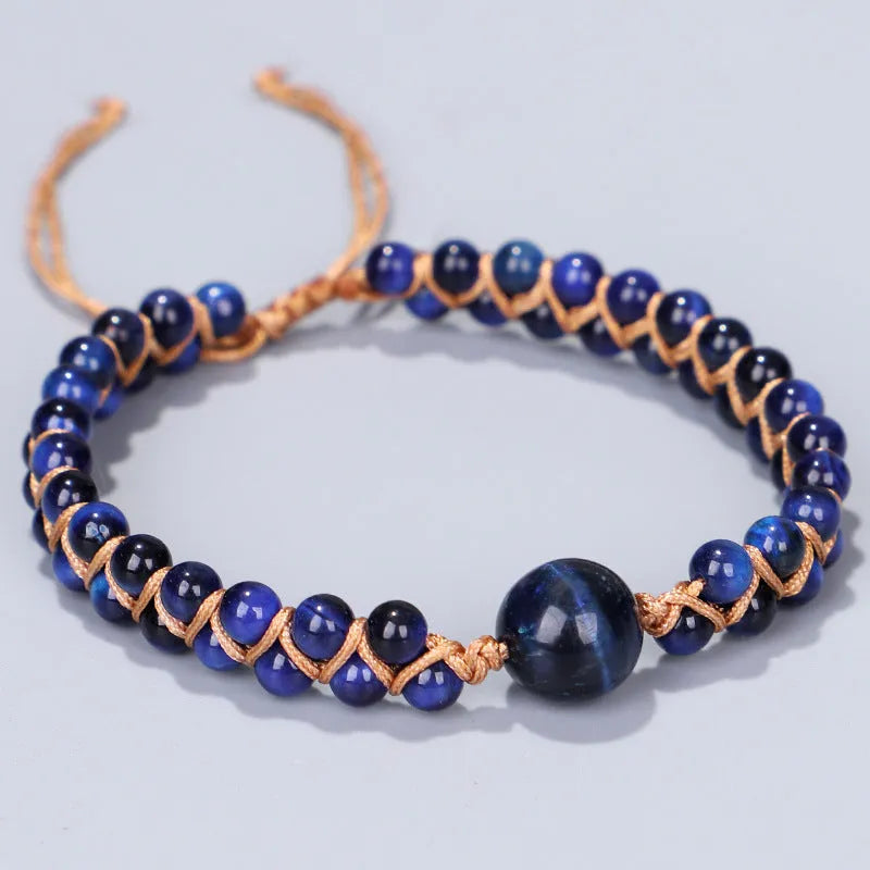 Handmade woven geometric bracelet with blue tigereye stone beads and adjustable pull closure.