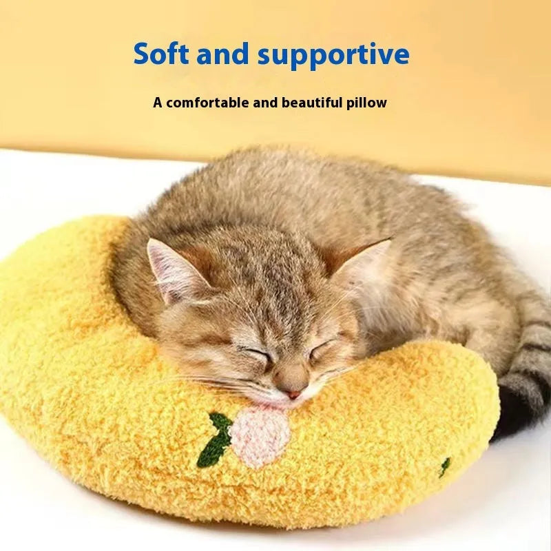 Blue question mark shaped cloth pillow for cat neck support on a pet sleeping mat