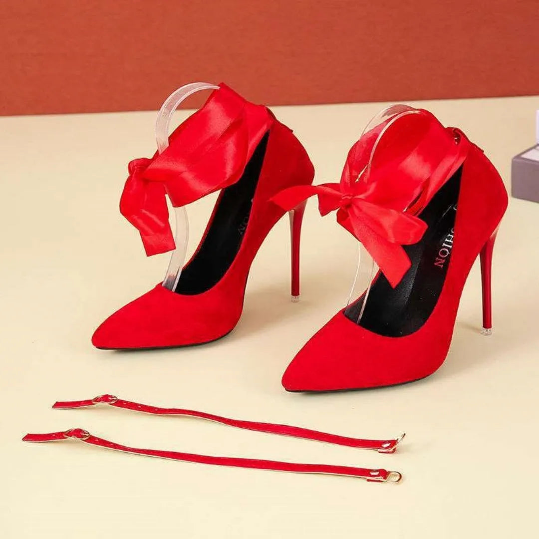 Black pointed toe stiletto shoe with shallow mouth design and a fabric strap with flat buckle