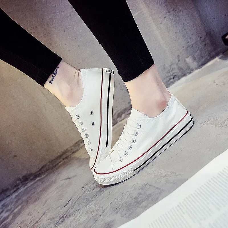Women's solid-colour casual canvas shoes in black, white and black, white and red, or all black colourways.