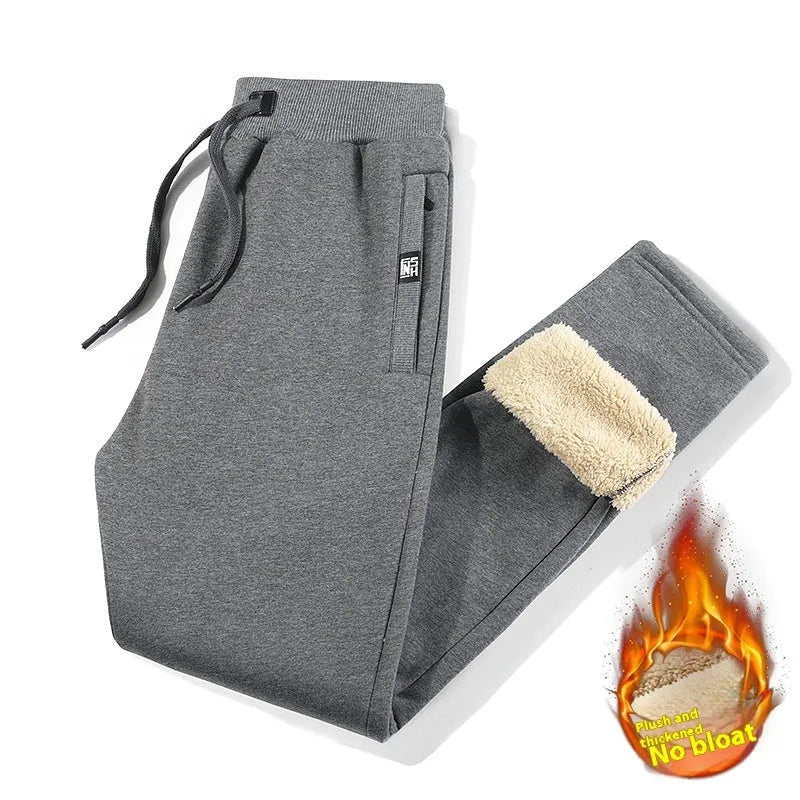 Men's grey fleece-lined oversized cotton track pants on a hanger.
