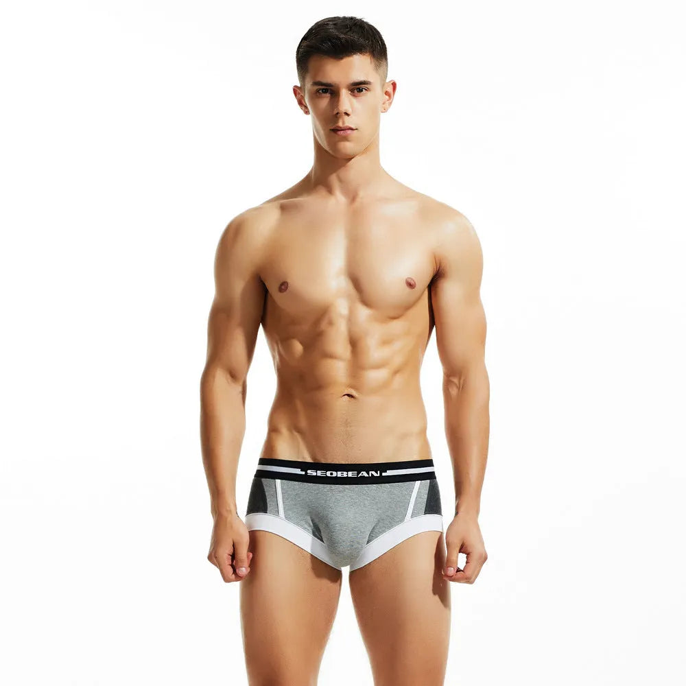 Men's cotton low-waist boxers in red, dark blue and light grey colours showing hip-lifting design