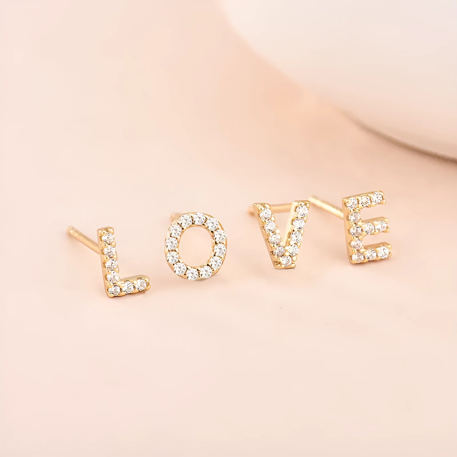 Gold plated brass alphabet letter earrings with zircon detailing showing A-Z character range