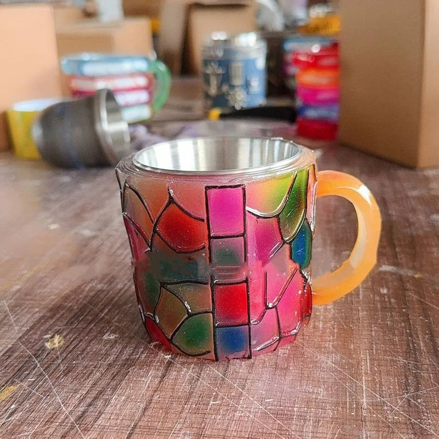 Synthetic resin decorative coffee cup ornament with painted book design.