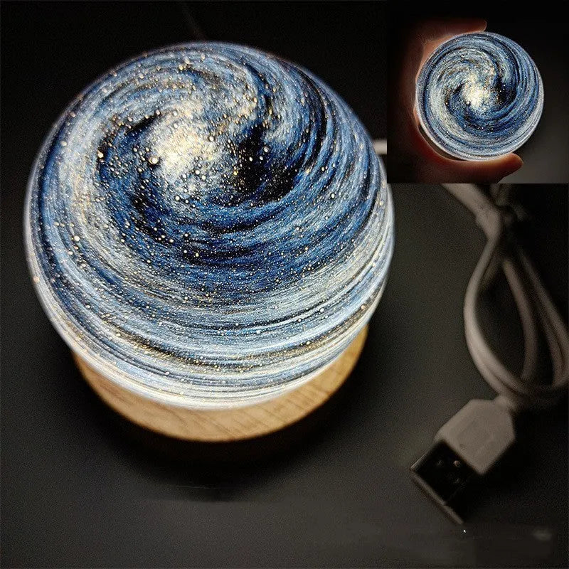 Compact modern planet USB night light on its base with dimmable three-colour lighting.