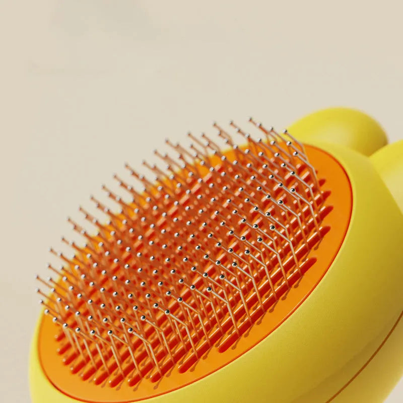 Self-cleaning pet grooming brush with release button in green, pink, purple or yellow