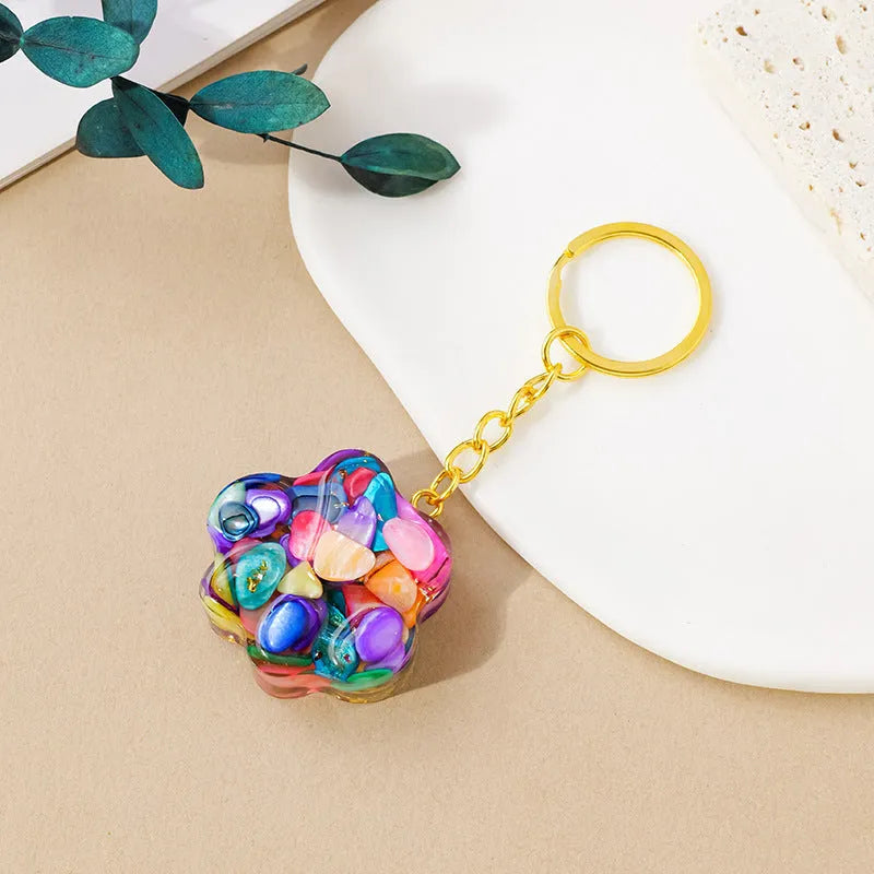 Natural crystal cat's paw keychain pendant in various gemstone colours including pink, red, blue, and green