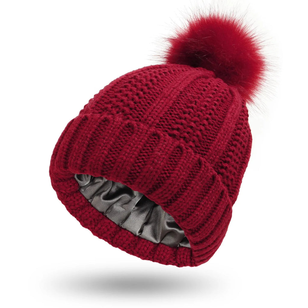 Wool knit beanie hat for women with faux fur pom pom and satin lining in beige colour