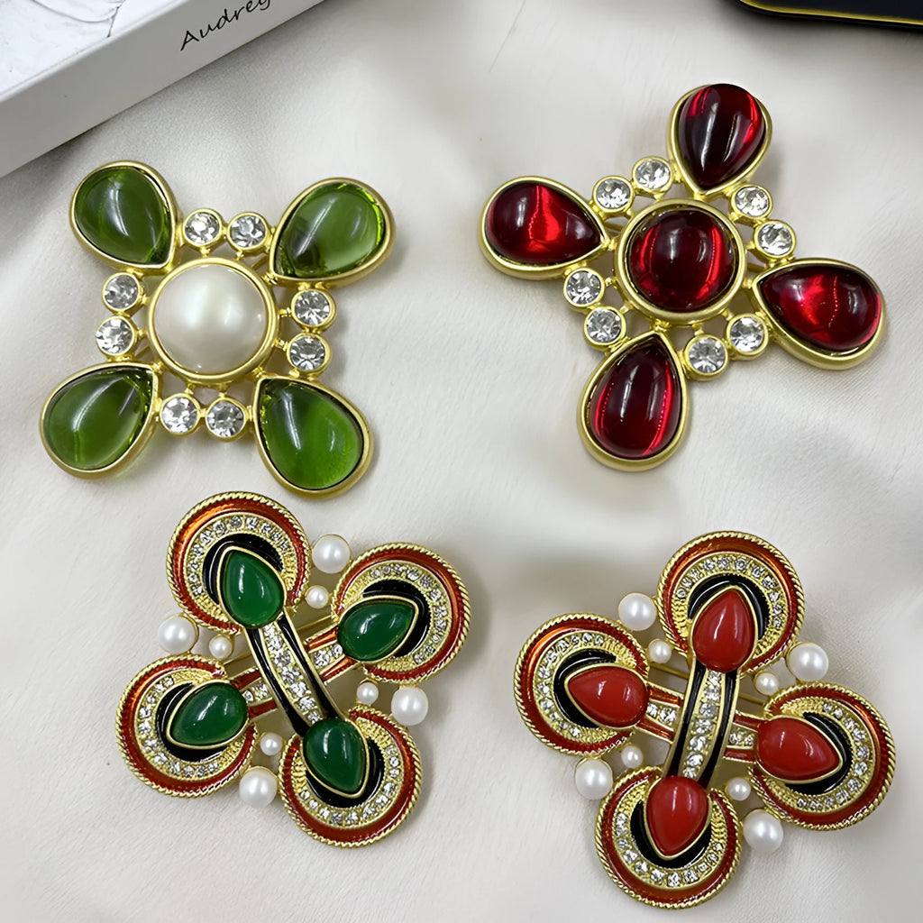 A vintage-style zinc alloy brooch with a baroque cross design and crystal accents.