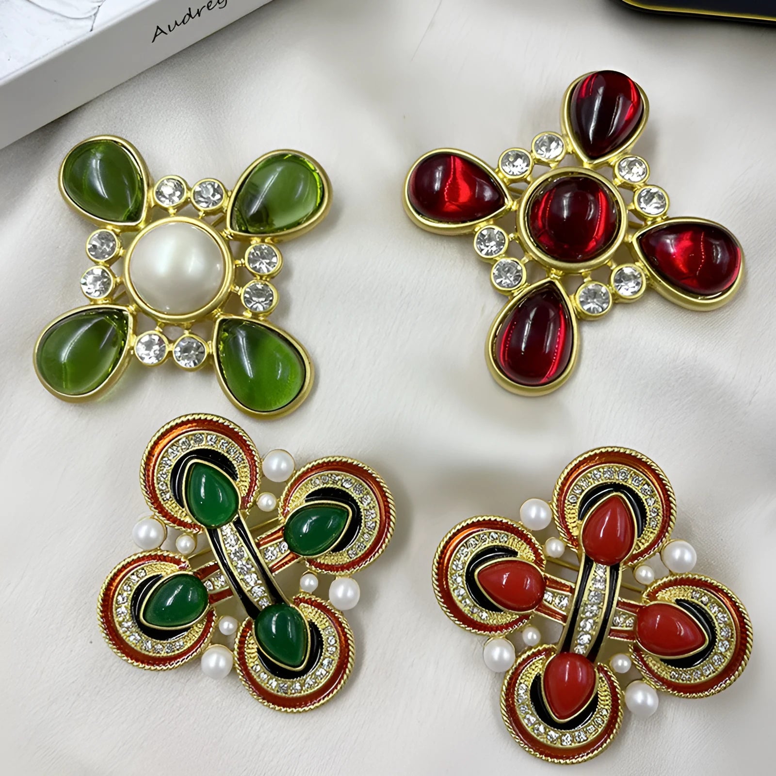 A vintage-style zinc alloy brooch with a baroque cross design and crystal accents.