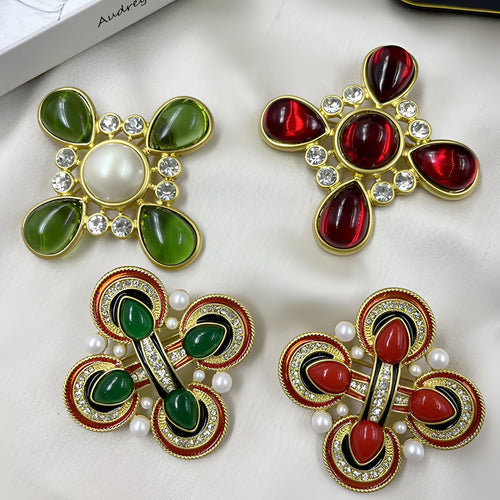 A vintage-style zinc alloy brooch with a baroque cross design and crystal accents.