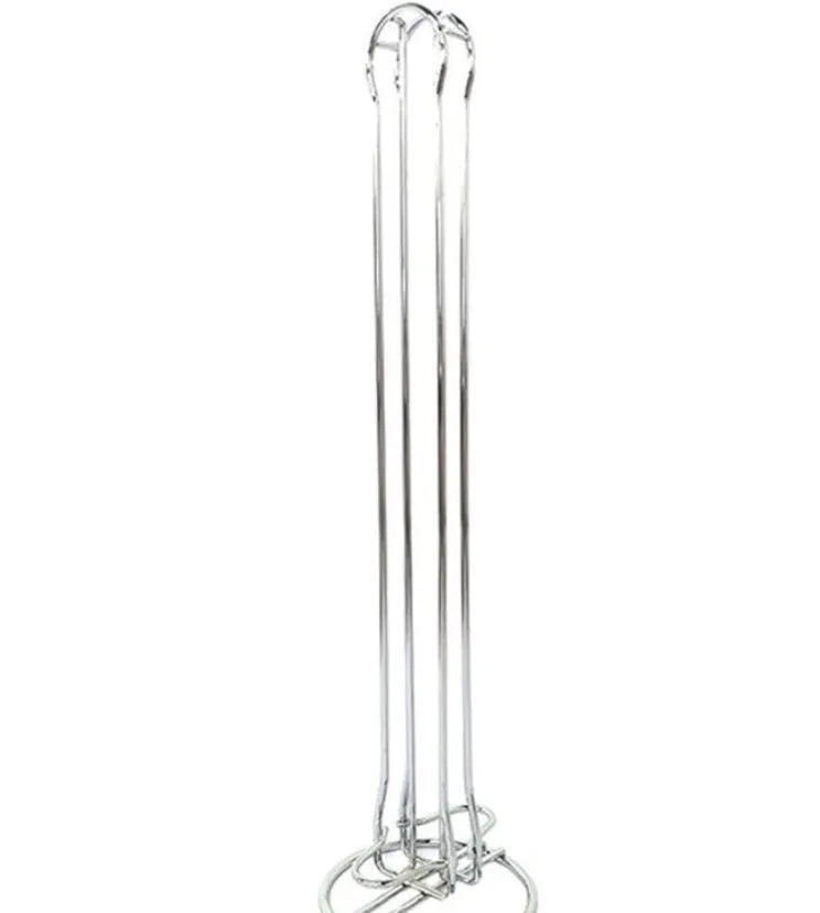 Black wrought iron coffee capsule storage rack holding pods on two shelves.