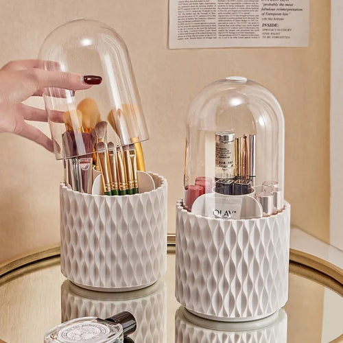 White acrylic rotating makeup brush holder with transparent dust cover on desktop
