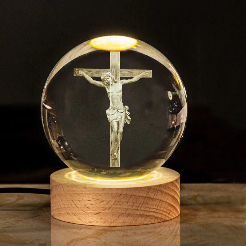 White crystal ball ornament with wood base and warm light, showing detailed internal design.