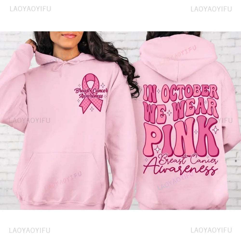 Pink pullover hoodie with a breast cancer awareness slogan, retro graphic, and side seam pockets.