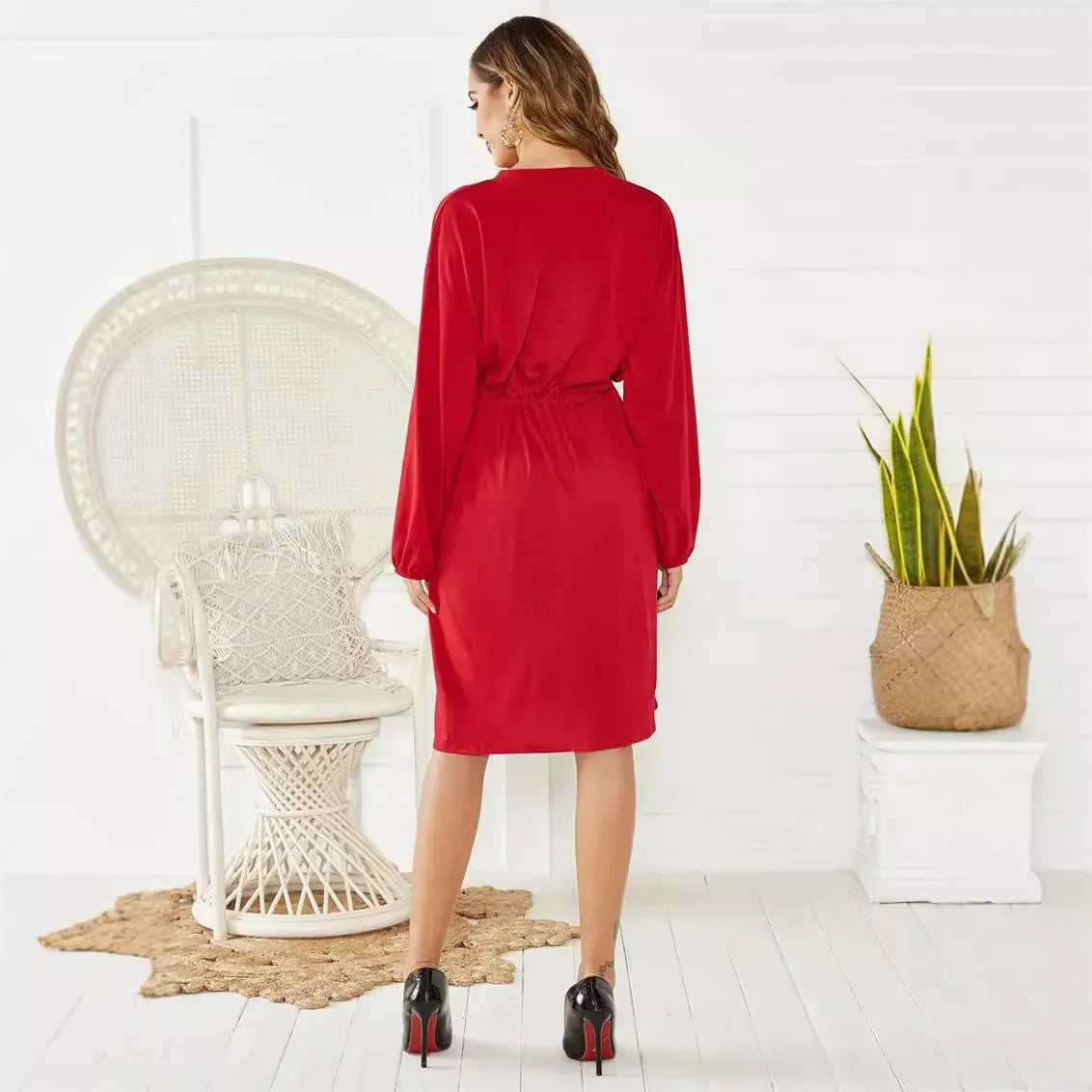 Women's black A-line midi dress with cinched waist belt and long sleeves on hanger