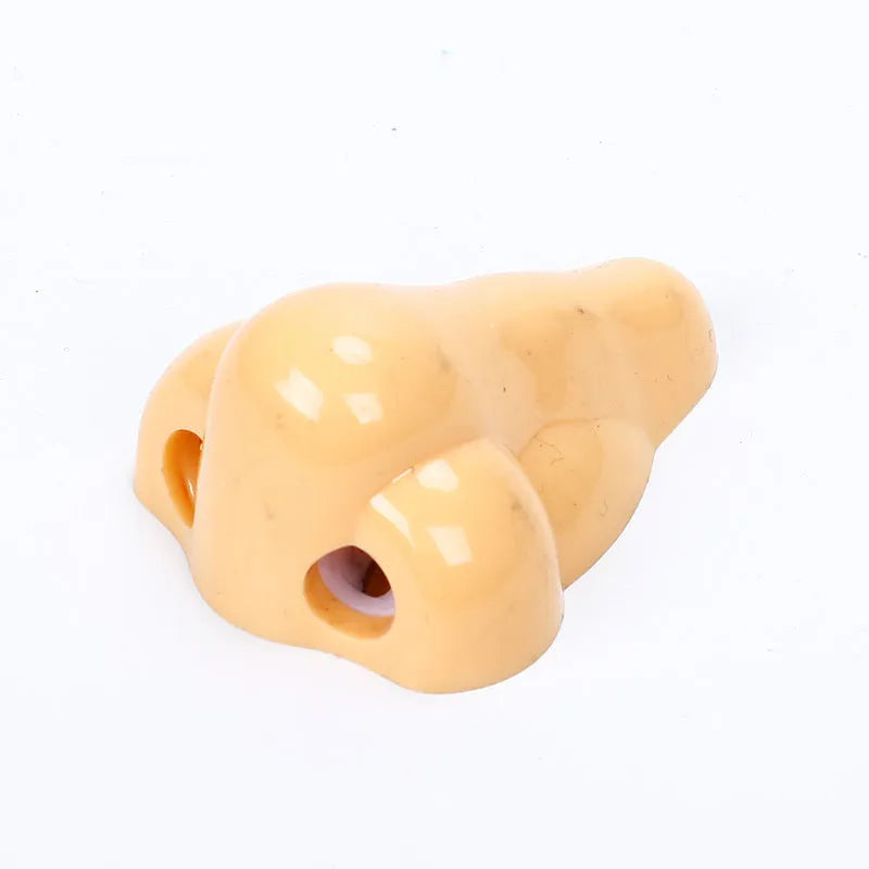 Flesh colour geometry-shaped plastic pencil sharpener with big nostril.