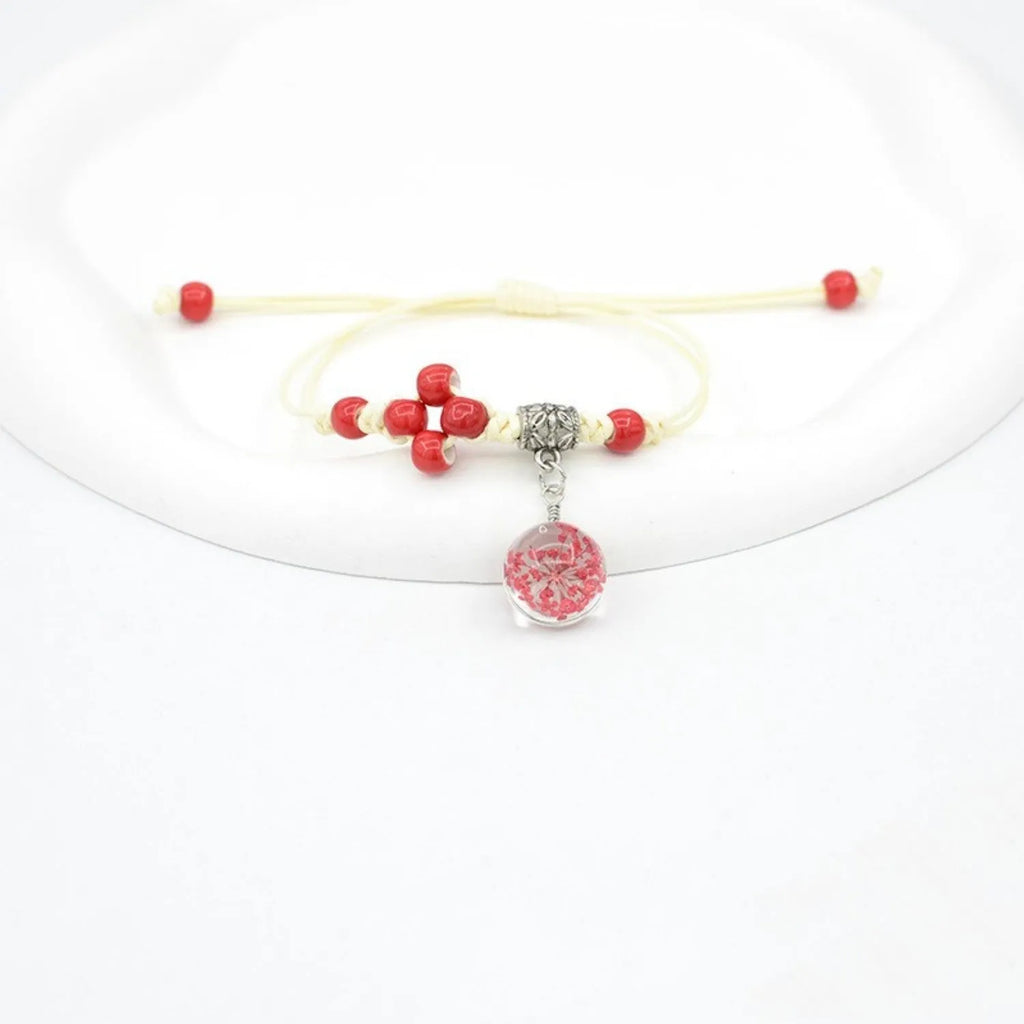 Hand-woven glass bracelet with large 1.4cm beads containing dried real flowers, shown in multiple colour options.