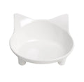 White and black shallow melamine pet bowls with non-slip rubber bases on a floor.