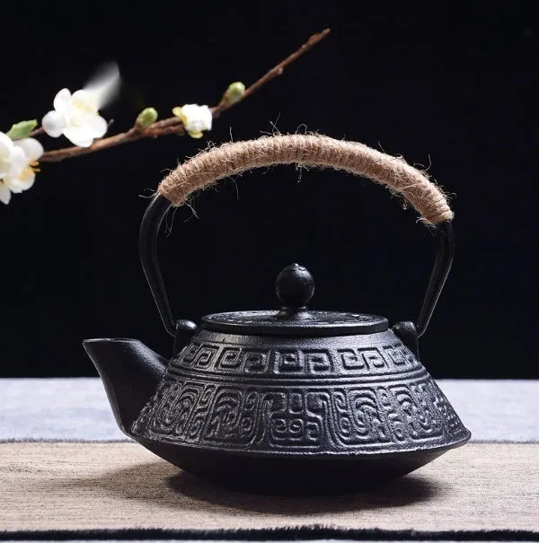 A cast iron teapot with Japanese-style hand-painted decoration, shown in a Bronze finish, with a capacity of 0.9 litres.