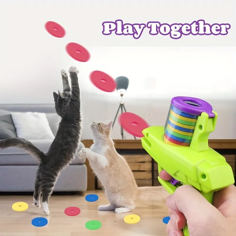 Interactive cat toy launcher firing foam disc with green plastic construction