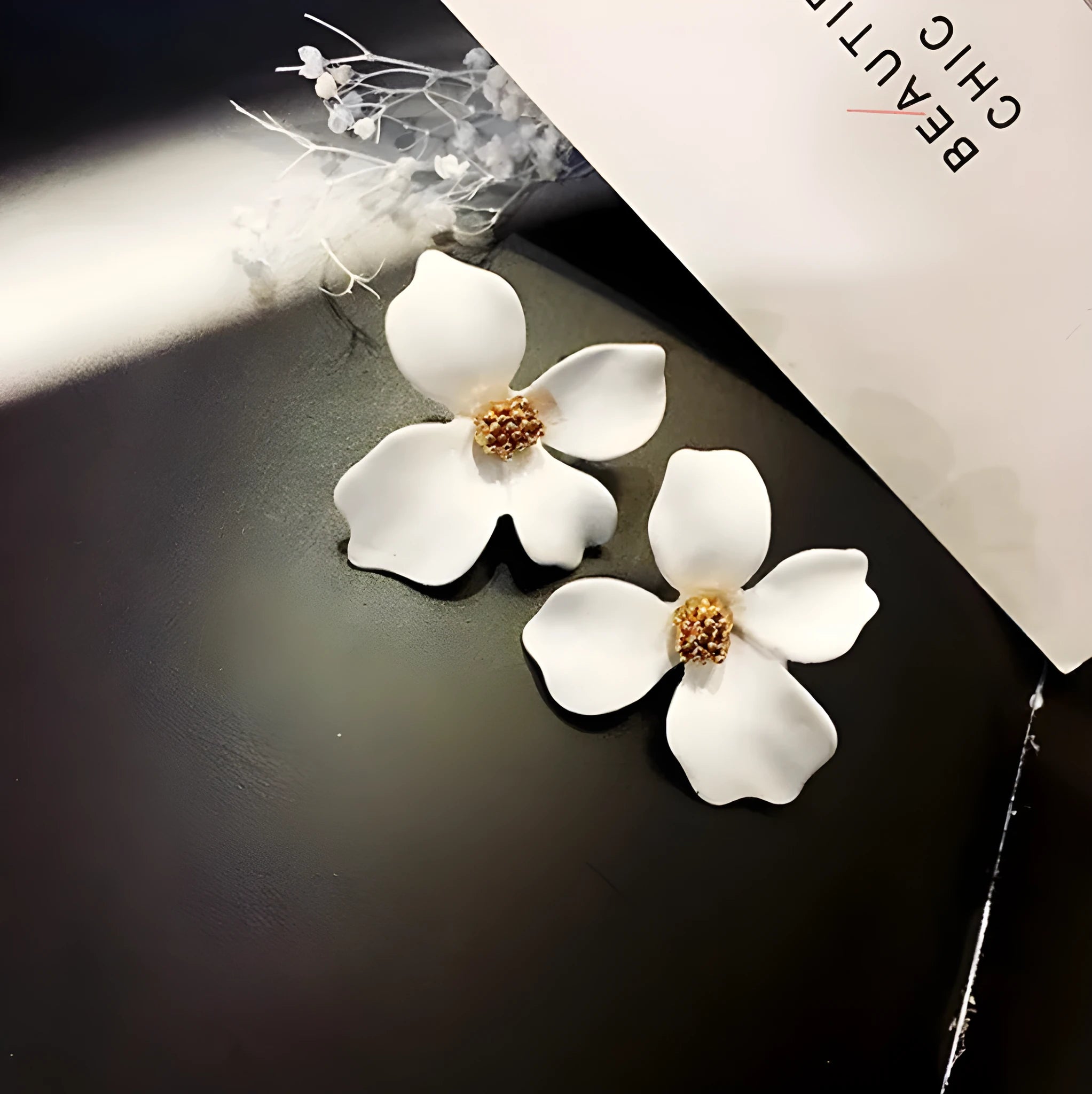 Women's flower stud earrings with electroplated pink or white finish on alloy construction