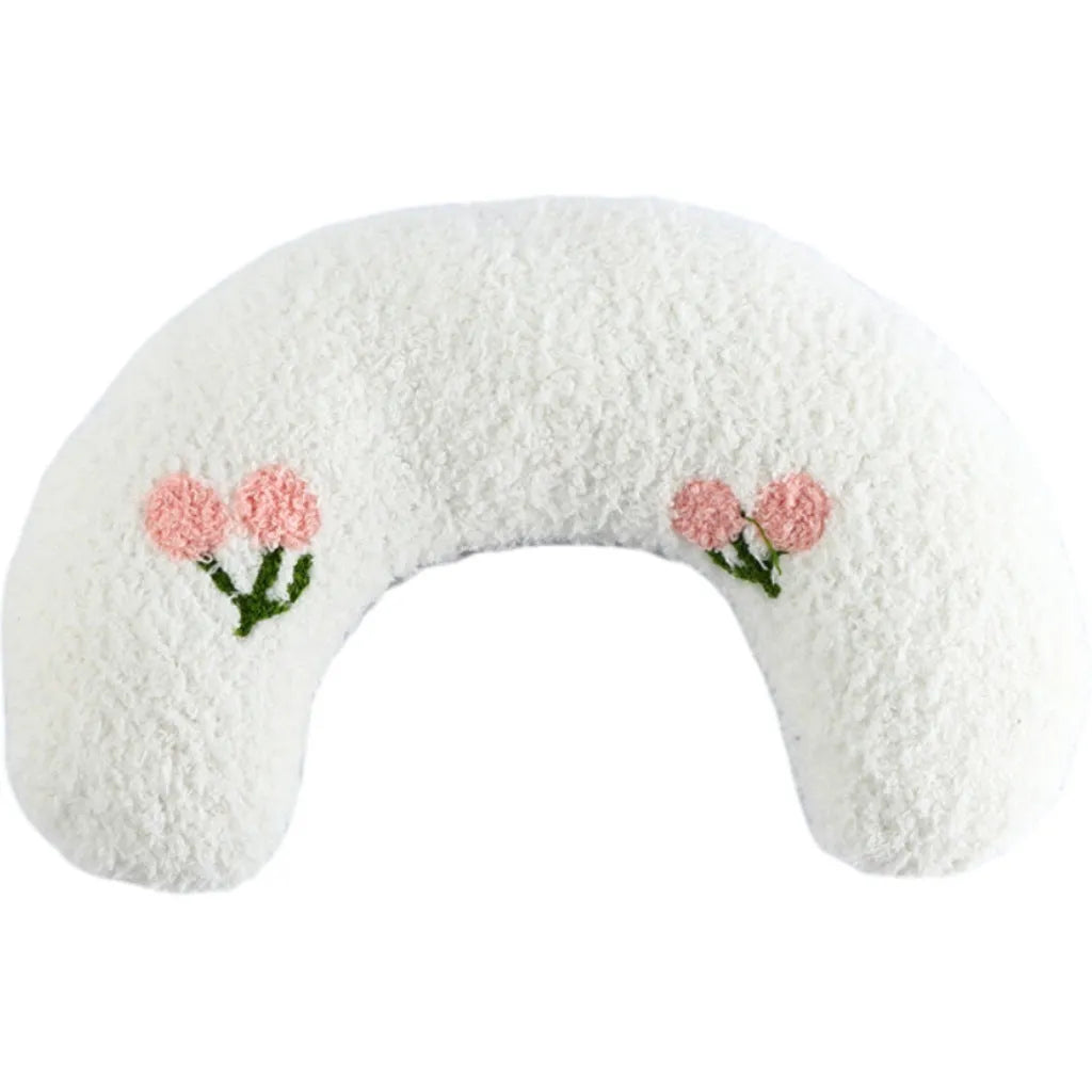 Small blue U-shaped plush pillow for cats or small dogs on a white background.