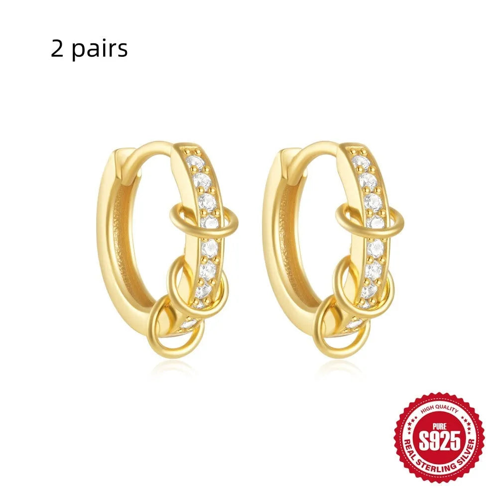 Sterling silver geometric stud earrings with a small round shape and classic diamond detail on a white background.