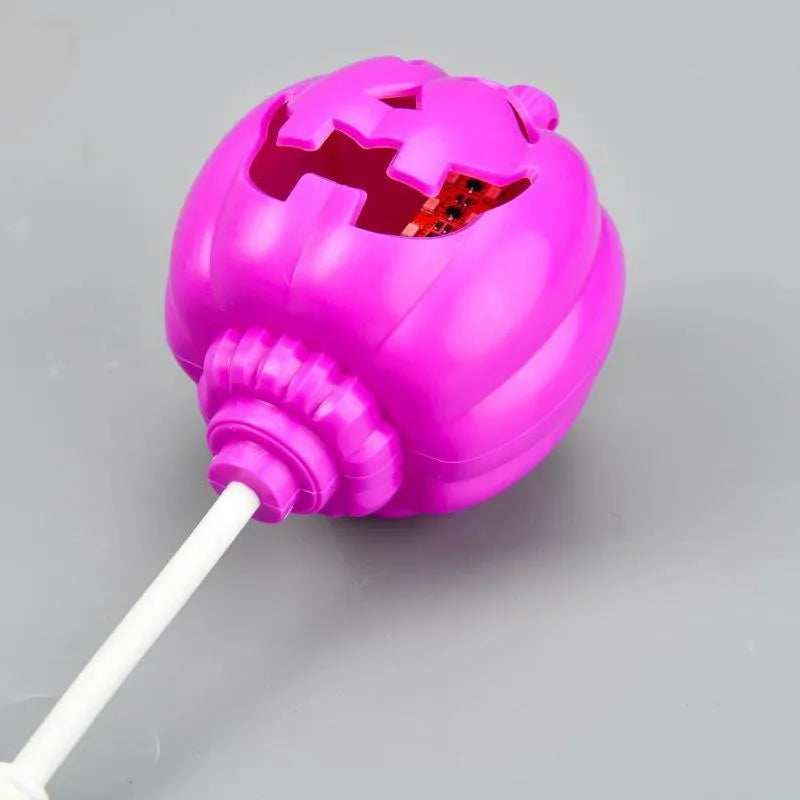 Plastic pumpkin-shaped lamp with USB charging cable, showing purple light option.