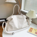 Soft surface messenger bag with adjustable strap showing mobile phone pocket and zipper compartments