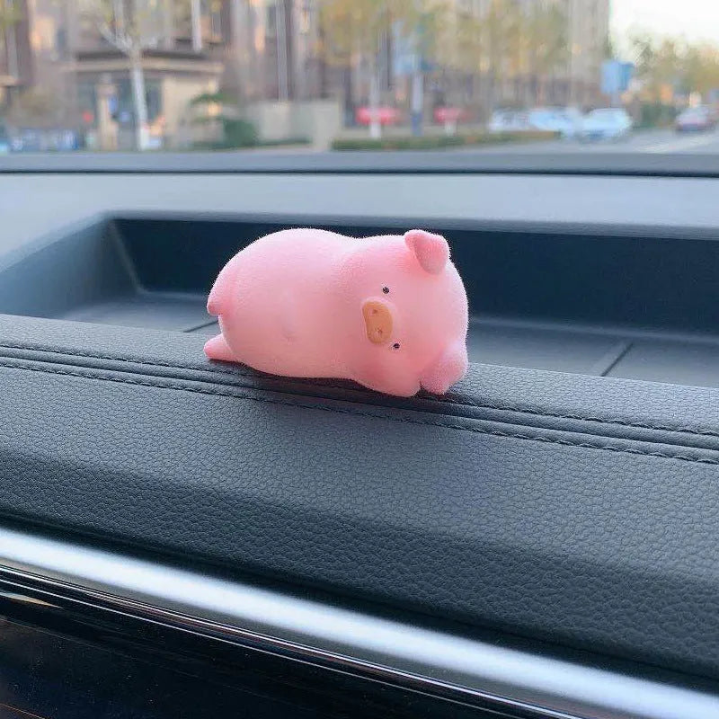 Cute cartoon pig resin figurine designed as a car dashboard decoration accessory.