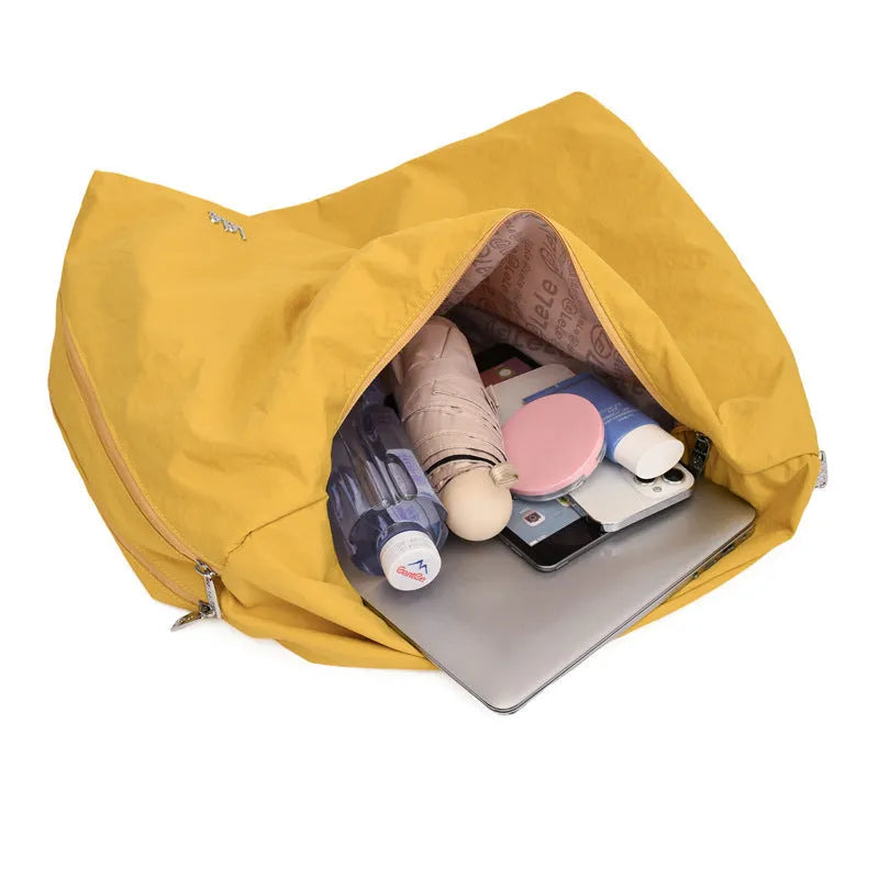 Heart-shaped soft nylon crossbody bag for women in black, blue, khaki, or yellow.